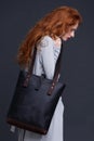 Red hair fashion model holding large leather bag Royalty Free Stock Photo