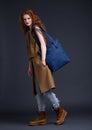 Red hair fashion model holding large leather bag Royalty Free Stock Photo