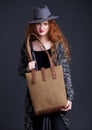 Red hair fashion model holding large leather bag Royalty Free Stock Photo