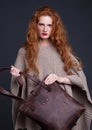 Red hair fashion model holding large leather bag Royalty Free Stock Photo