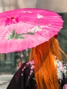 Red Hair Girl with Traditional Japanese Pink Wagasa Umbrella Royalty Free Stock Photo