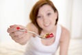 Red hair happy woman eating cereal stawberries Royalty Free Stock Photo