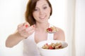 Red hair happy woman eating cereal stawberries Royalty Free Stock Photo