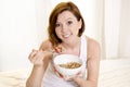 Red hair happy woman eating cereal stawberries Royalty Free Stock Photo