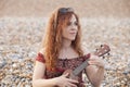 Red hair woman playing ukulele Royalty Free Stock Photo