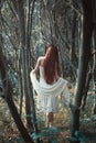 Red hair woman in weird forest