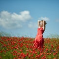 Red haired beautiful girl in poppy field Royalty Free Stock Photo