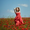 Red haired beautiful girl in poppy field Royalty Free Stock Photo