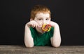 a red-haired boy with a Lollipop, close up Royalty Free Stock Photo