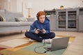 Red Haired Boy Playing Video Games on Floor Royalty Free Stock Photo