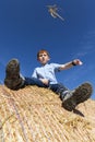 red-haired boy sitting on a golden stack Royalty Free Stock Photo