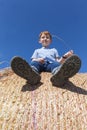 red-haired boy sitting on a golden stack