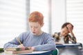 Red Haired Boy Taking Test in Class Royalty Free Stock Photo