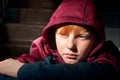 A red-haired boy, a twelve-year-old teenager, with an anxious expression on his face, Royalty Free Stock Photo