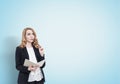 Red haired businesswoman with a copybook, blue Royalty Free Stock Photo