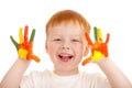 Red-haired child hands painted in bright colors