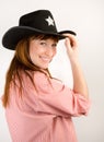 Red haired cowgirl in hat looking to the camera Royalty Free Stock Photo