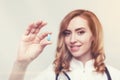 Red haired doctor with a blue pill Royalty Free Stock Photo