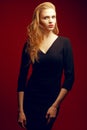 Red-haired (ginger) fashionable model in black dress