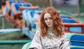 Red-haired girl in an amusement park