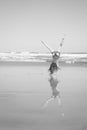 Red haired girl doing a hand stand or cartwheel on a New Zealand surf beach Royalty Free Stock Photo