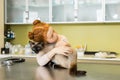 Red haired girl embrace her cat at veterinary clinic Royalty Free Stock Photo