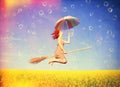 Red-haired girl flying with umbrella Royalty Free Stock Photo