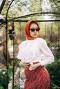 Red-haired girl with freckles in cherry blossom Royalty Free Stock Photo