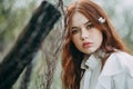 Red-haired girl with freckles in cherry blossom Royalty Free Stock Photo