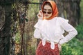 Red-haired girl with freckles in cherry blossom Royalty Free Stock Photo