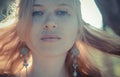 Red-haired girl with freckles in earrings, Royalty Free Stock Photo