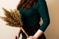 A red-haired girl in a green jacket with a reed Royalty Free Stock Photo