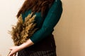 A red-haired girl in a green jacket with a reed Royalty Free Stock Photo