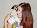 Red-haired girl holding a puppy Jack Russell. Royalty Free Stock Photo