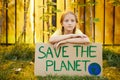 Red Haired Girl Holding Save the Planet Sign