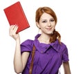Red-haired girl keep book in hand.