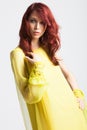 Red-haired girl in long elegant yellow dress