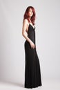 Red-haired girl in long evening black dress Royalty Free Stock Photo