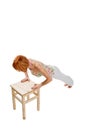 Red haired girl performing fitness exercises