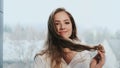 Red-Haired Girl Plays With Her Long Hair.