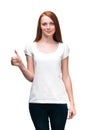 Red-haired girl shows finger on t-shirt. Isolated on white back