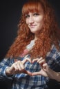 Red-haired girl shows heart