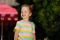 Red-haired girl in a striped colored T-shirt Royalty Free Stock Photo