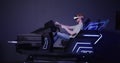 A red-haired guy in virtual reality glasses controls the simulator in 5D