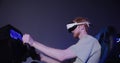 A red-haired guy in virtual reality glasses controls the simulator in 5D