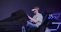 A red-haired guy in virtual reality glasses controls the simulator in 5D