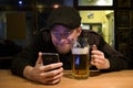 Guy and phone in the bar Royalty Free Stock Photo