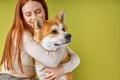 Red-haired lady in casual wear hugging purebred pet dog, akita inu dog with owner Royalty Free Stock Photo