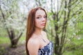 Red-haired lady in spring orchard Royalty Free Stock Photo