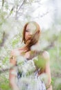 Red-haired lady in spring orchard Royalty Free Stock Photo